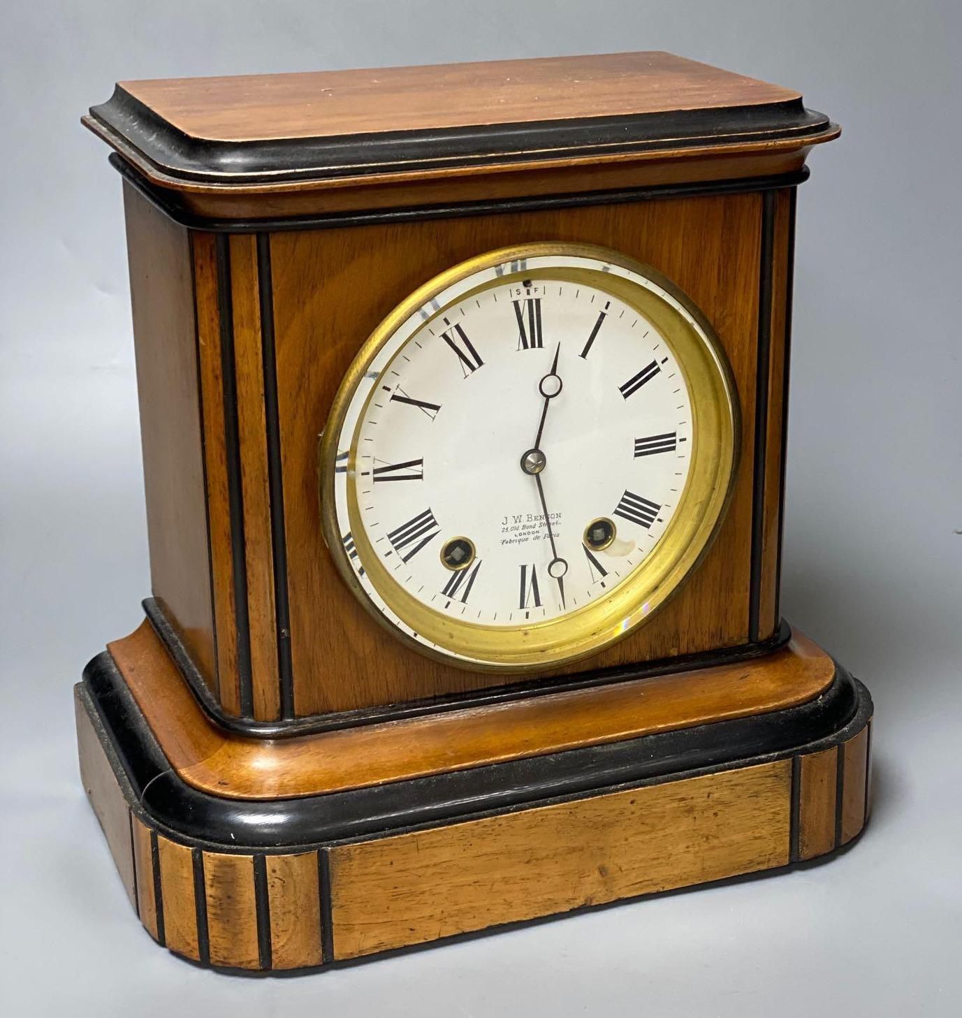 A walnut cased and ebonised mantel clock retailed by JW Benson, French movement striking on a gong, height 27cm